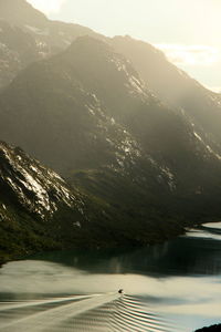 Scenic view of river against mountains on sunny day