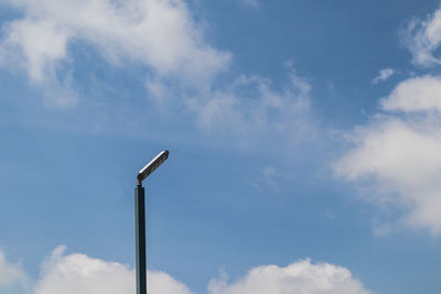 Low angle view of lighting equipment against sky