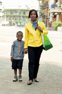 This young woman and her child ride in the street.