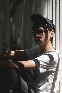 Side view of thoughtful young woman wearing eyeglasses