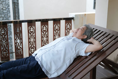 Senior woman relaxing on deck chair