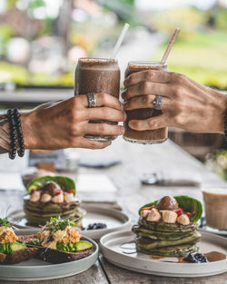 Close-up of man holding ice cream on table