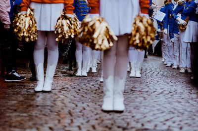 Low section of women standing on street