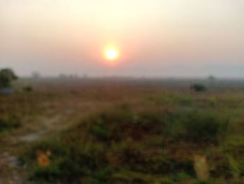 Scenic view of field against sky during sunset