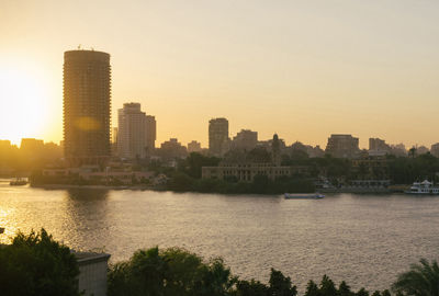 City at waterfront during sunset