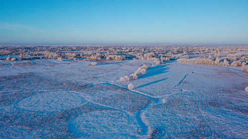 Aerial view of landscape against clear blue sky