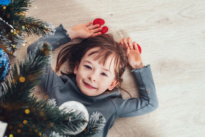 High angle view of girl playing with christmas tree
