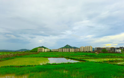 Built structure on field against sky