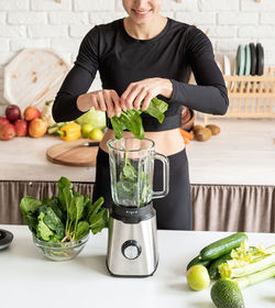 Midsection of woman preparing food in kitchen