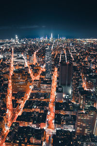 Aerial view of illuminated cityscape against sky at night