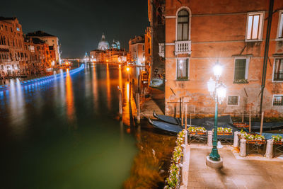 Canal passing through city at night