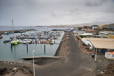 High angle view of marina at harbor against sky