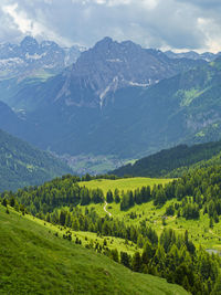 Scenic view of field and mountains against sky