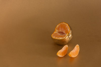 Close-up of fruit on table against orange background