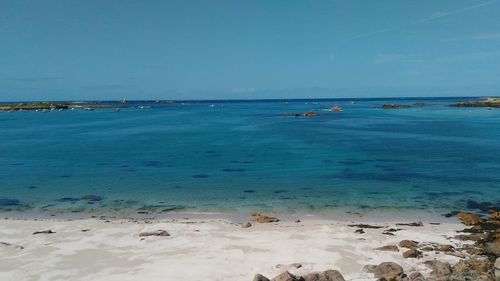 Scenic view of sea against clear blue sky