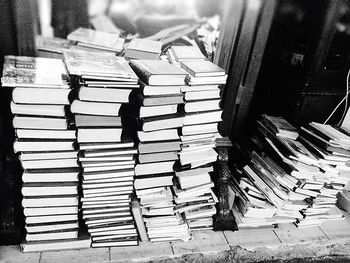 High angle view of books stacked on floor for sale at market