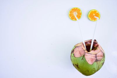 Directly above shot of orange fruit against white background