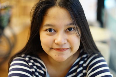 Close-up portrait of smiling woman 