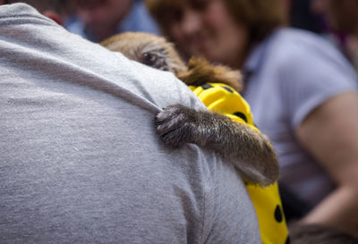 Midsection of man holding yellow dog