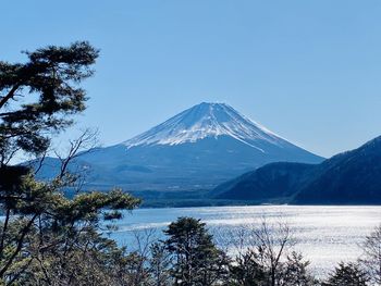 Scenic view of snowcapped mountain against blue sky