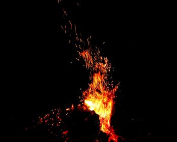 Close-up of bonfire against clear sky at night