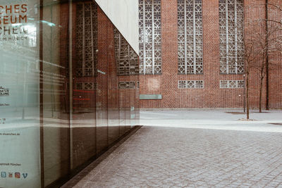 Empty road by building in city