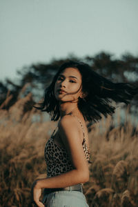 Young woman standing on field