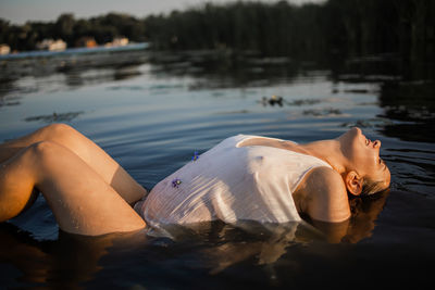 Woman in white dress in lake