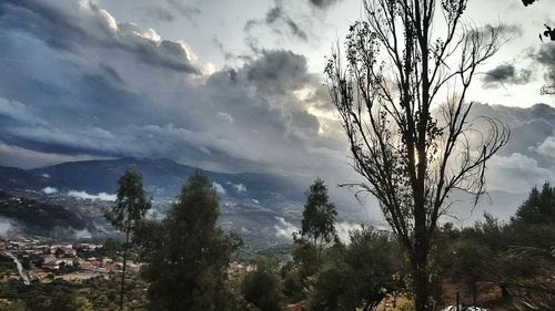 Scenic view of mountains against cloudy sky