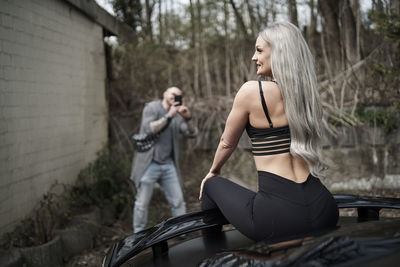 Side view of young woman standing in gym