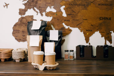 Disposable paper cups with coffee for takeaway food. packages with coffee on counter for self