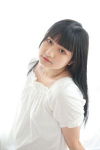 Portrait of beautiful young woman against white background