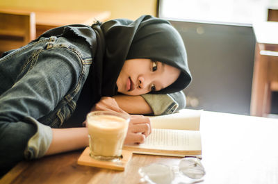 Portrait of boy sitting on table