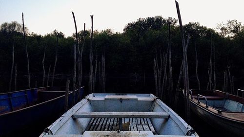 Boats moored on lake against sky