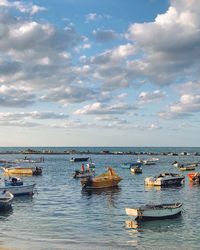 Boats moored in sea against sky