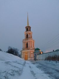 View of snow covered building against sky