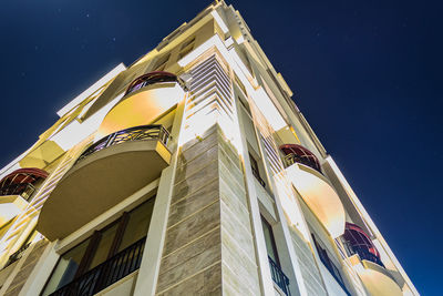 Low angle view of building against clear sky at night