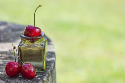 Close-up of apples in glass jar on table