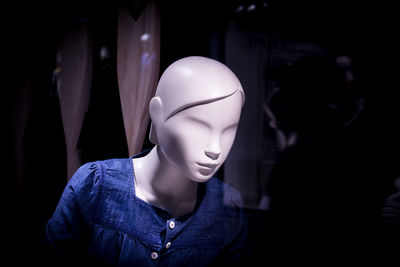 Close-up of illuminated mannequin at store