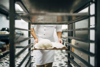 Baker working preparing tray to make bread