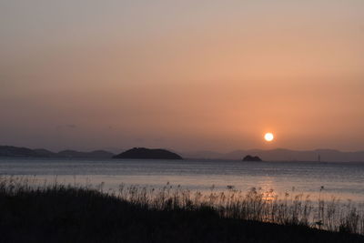 Scenic view of lake against sky during sunset