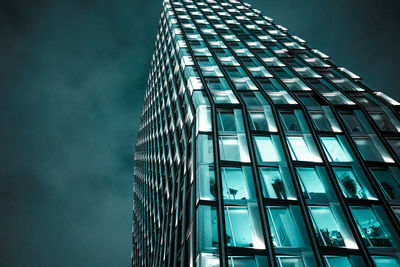 Low angle view of modern glass building against sky