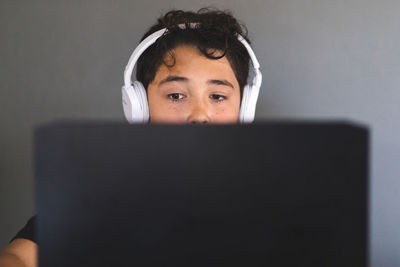 Boy doing his homework on laptop