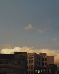 Low angle view of building against cloudy sky