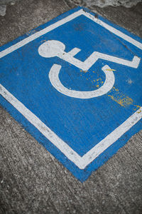 A disable sign on a street.