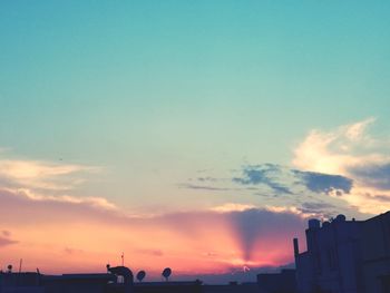 Low angle view of silhouette buildings against sky during sunset