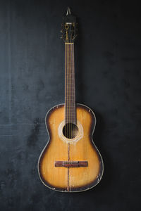 Close-up of guitar against wall
