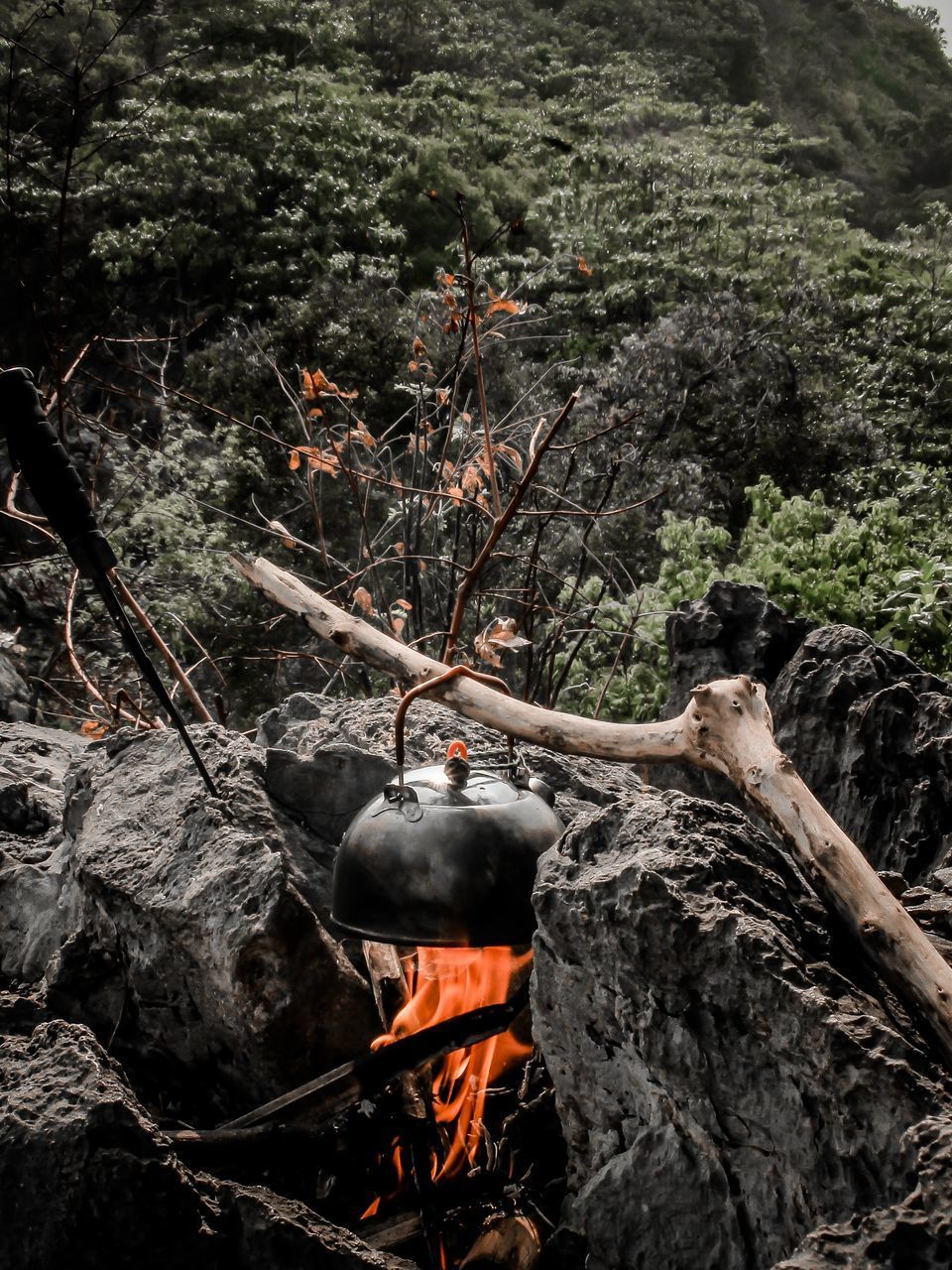 HIGH ANGLE VIEW OF BONFIRE ON ROCK