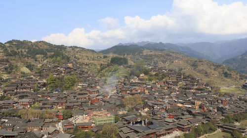 High angle view of townscape and mountains against sky