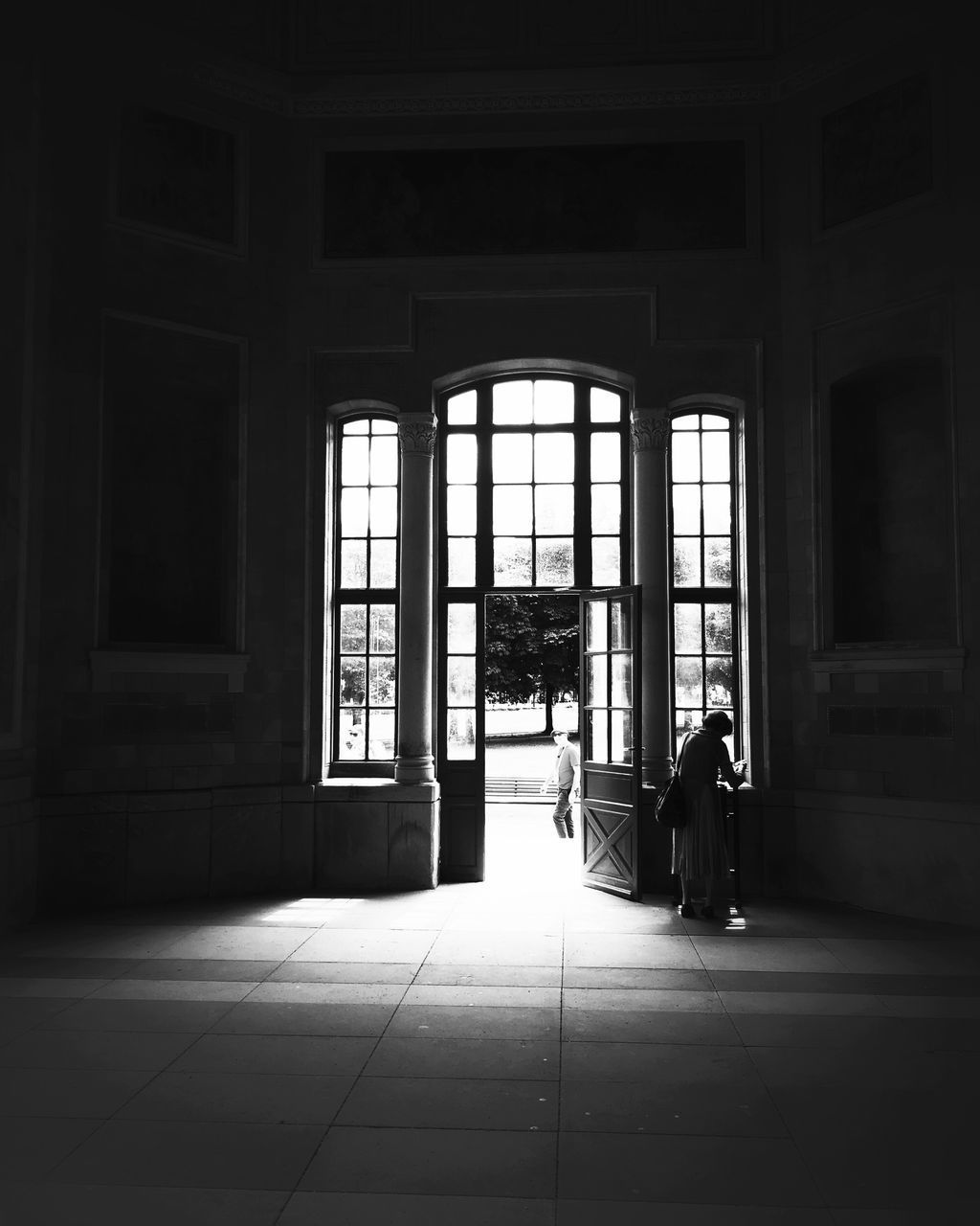 PEOPLE SITTING IN CORRIDOR OF BUILDING